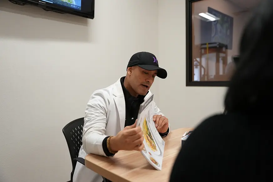 Registered dietitian reviewing a personalized nutrition plan with a client at KM Wellness Center in El Paso